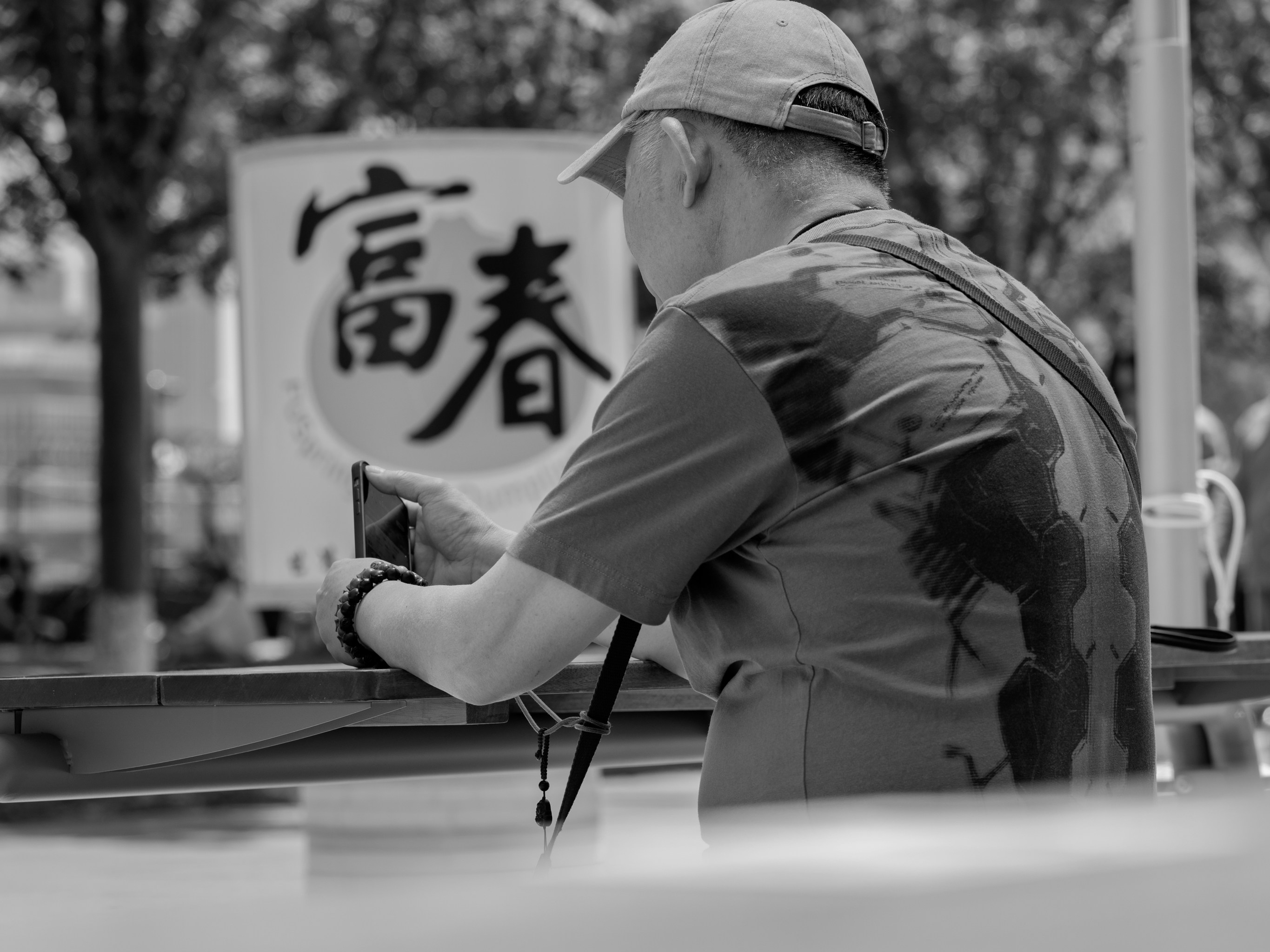 A man photographs a sign in a public area. photo – Free Man Image on ...