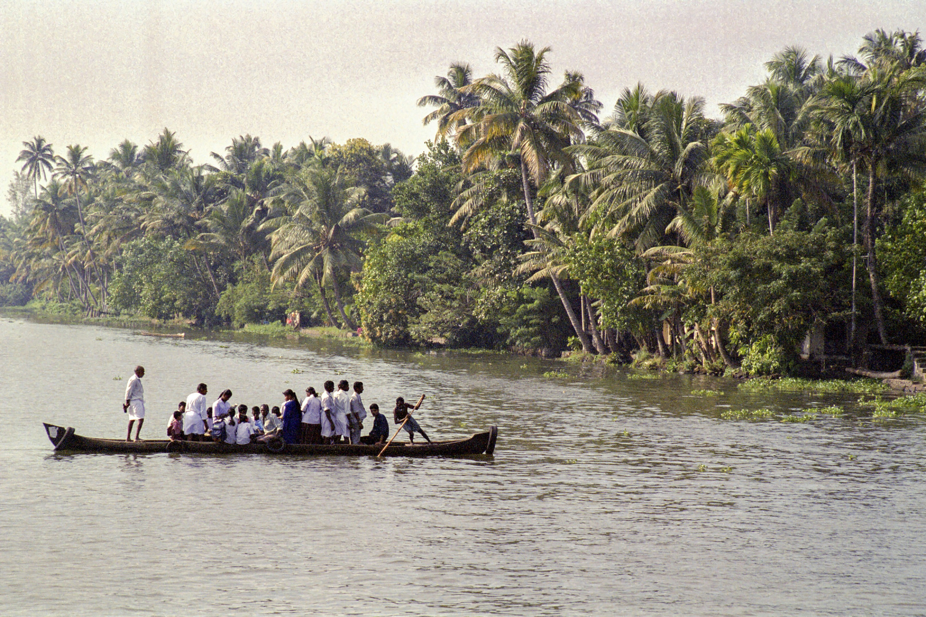 People ride a boat on a river.