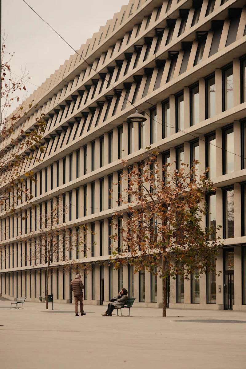 A striking modern concrete building facade with repeating vertical window bays