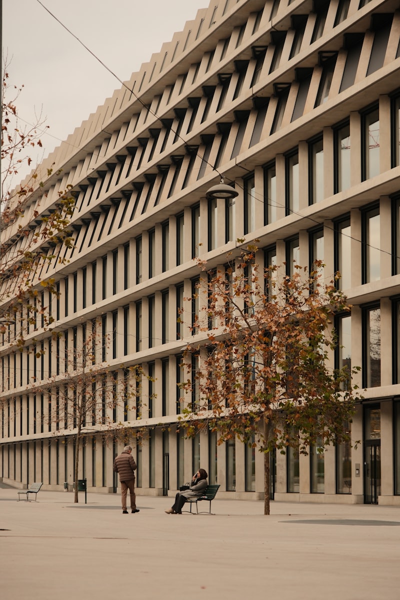 A striking modern concrete building facade with repeating vertical window bays