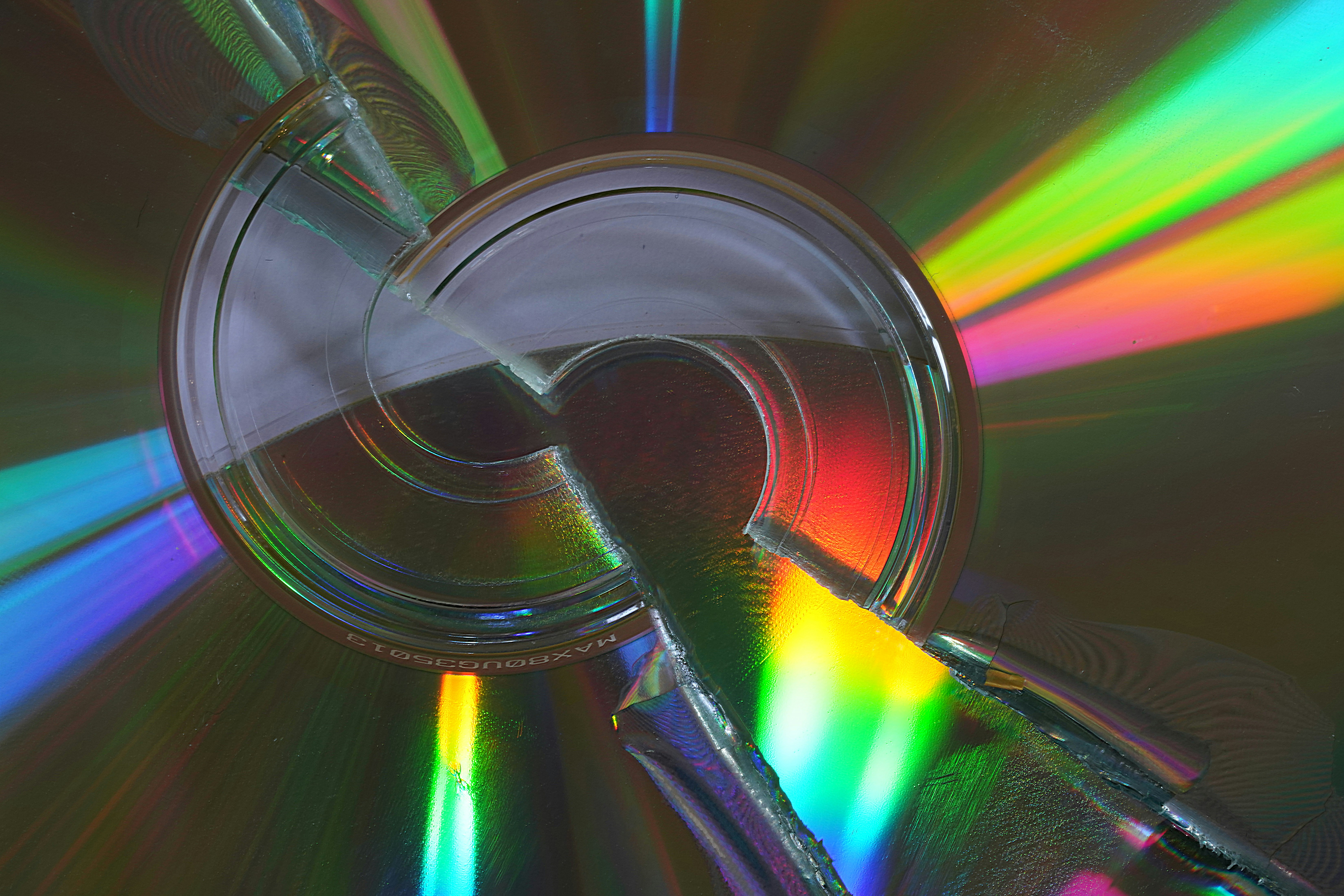 A cd reflecting colorful light is the focus.
