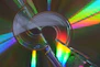A cd reflecting colorful light is the focus.