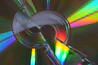 A cd reflecting colorful light is the focus.
