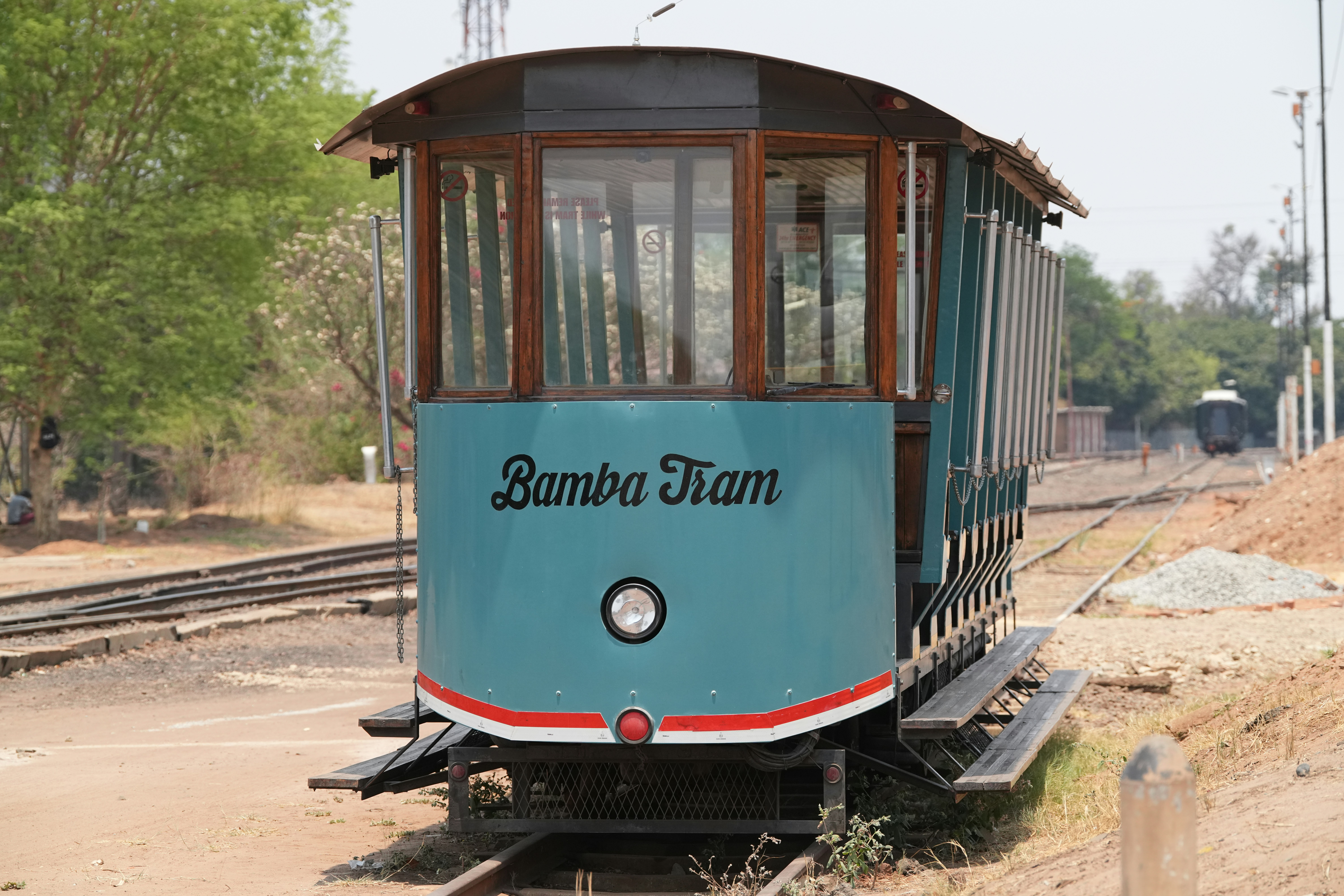 An old tram is sitting on the tracks.