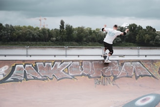 A skateboarder rides down the ramp.