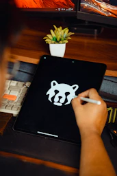 Someone is drawing a logo on their tablet.