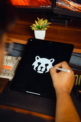 Someone is drawing a logo on their tablet
