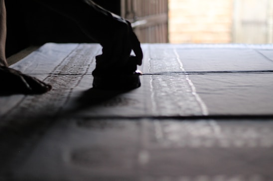 Someone is stamping a pattern onto fabric.