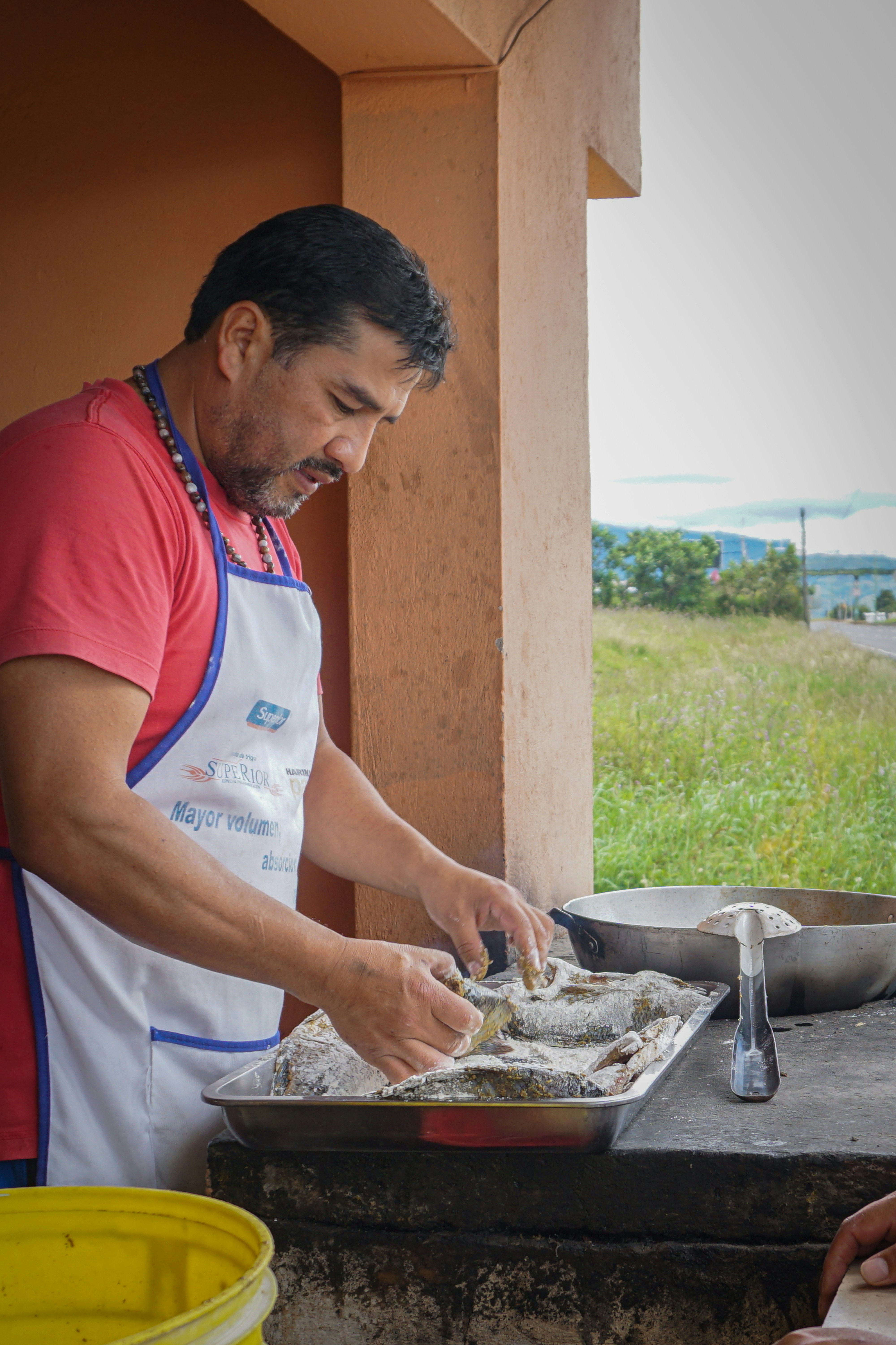 A man prepares fish for cooking.