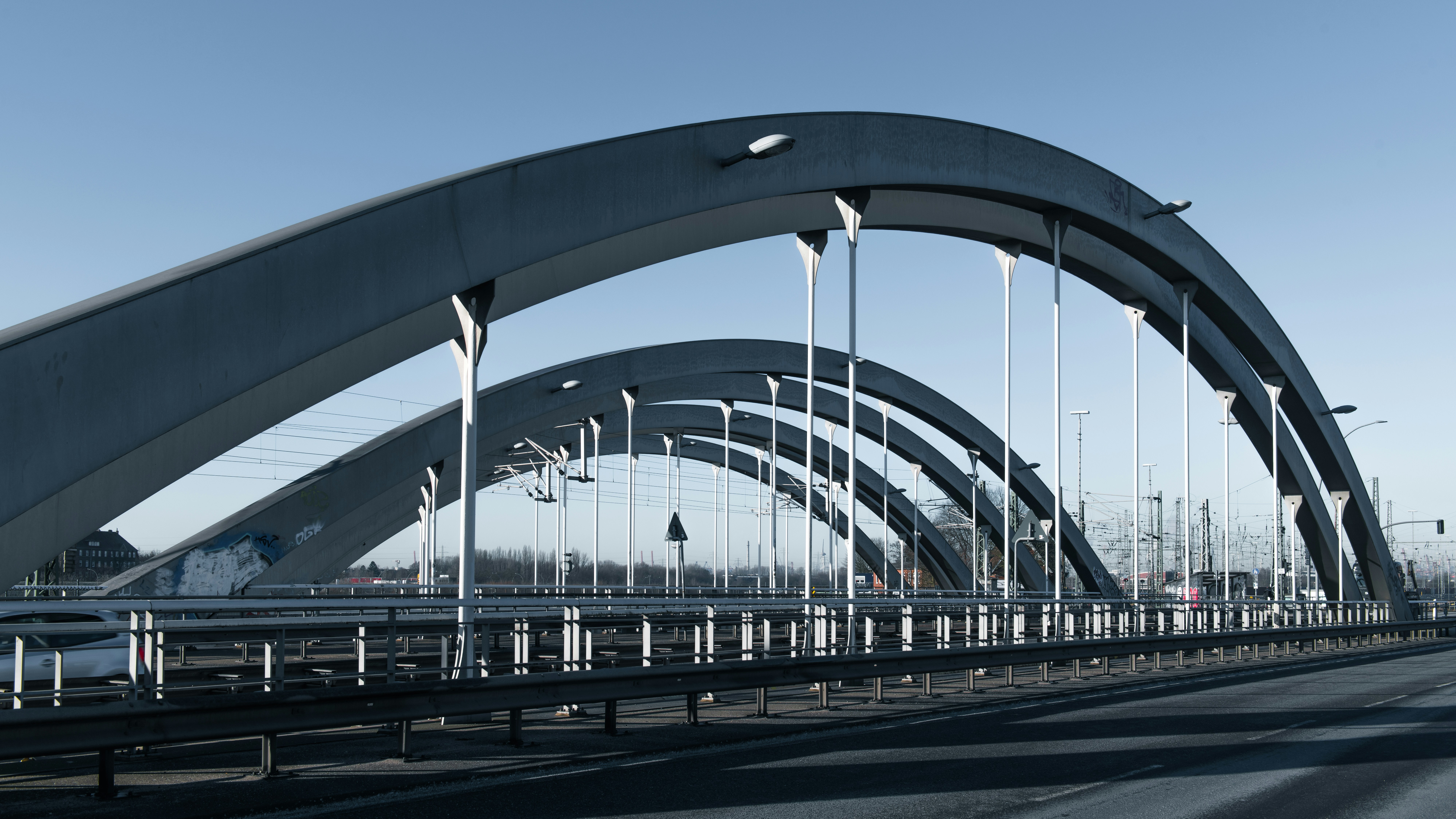 A bridge with two arches against a blue sky.