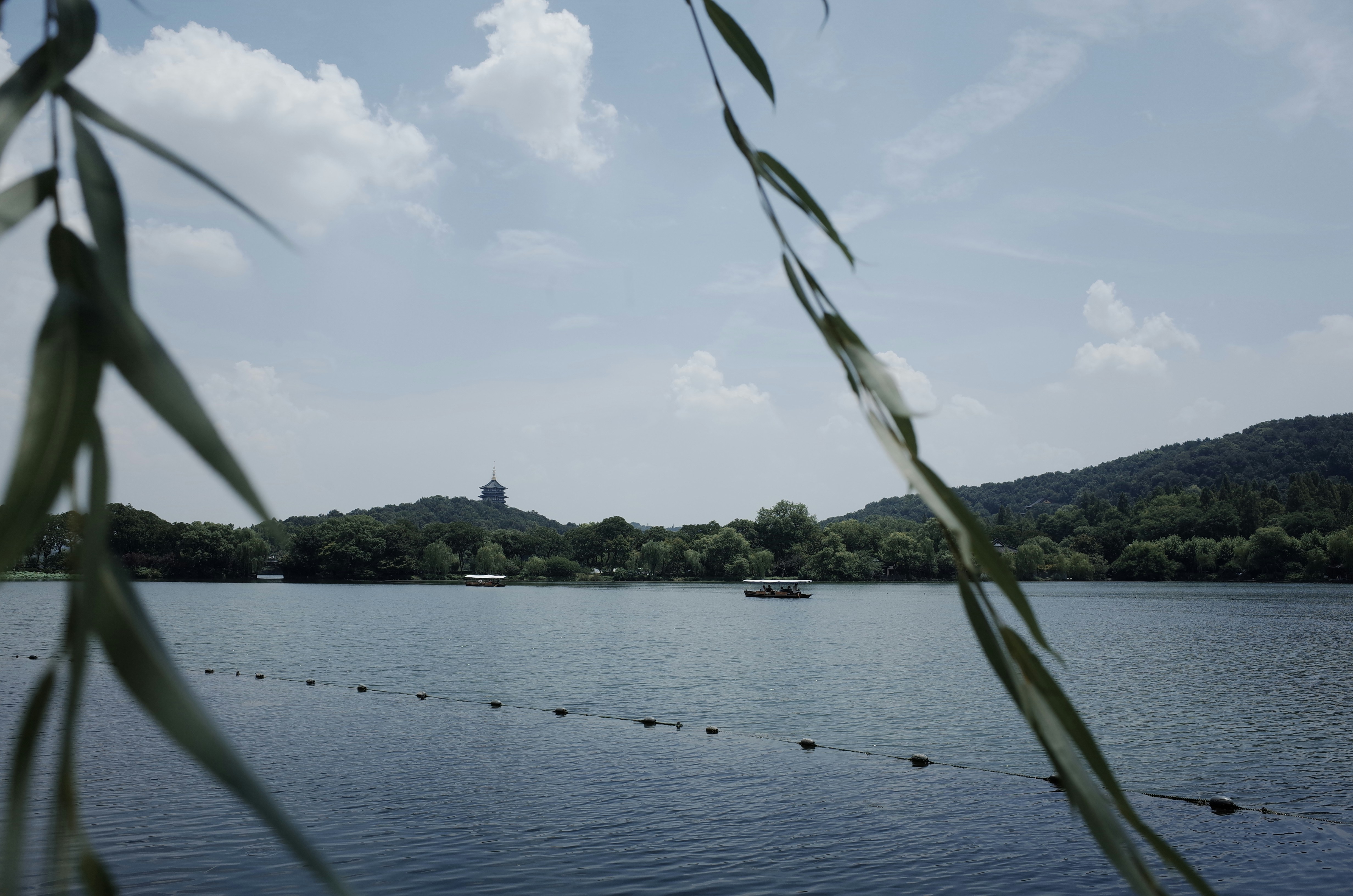 A lake scene with hills under a cloudy sky