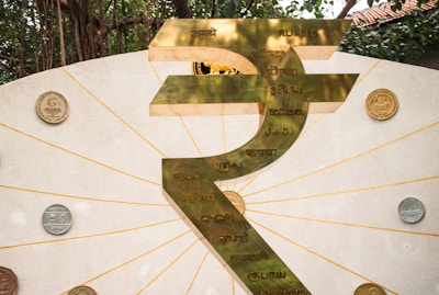 The image shows a large indian rupee symbol.