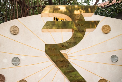 The image shows a large indian rupee symbol.