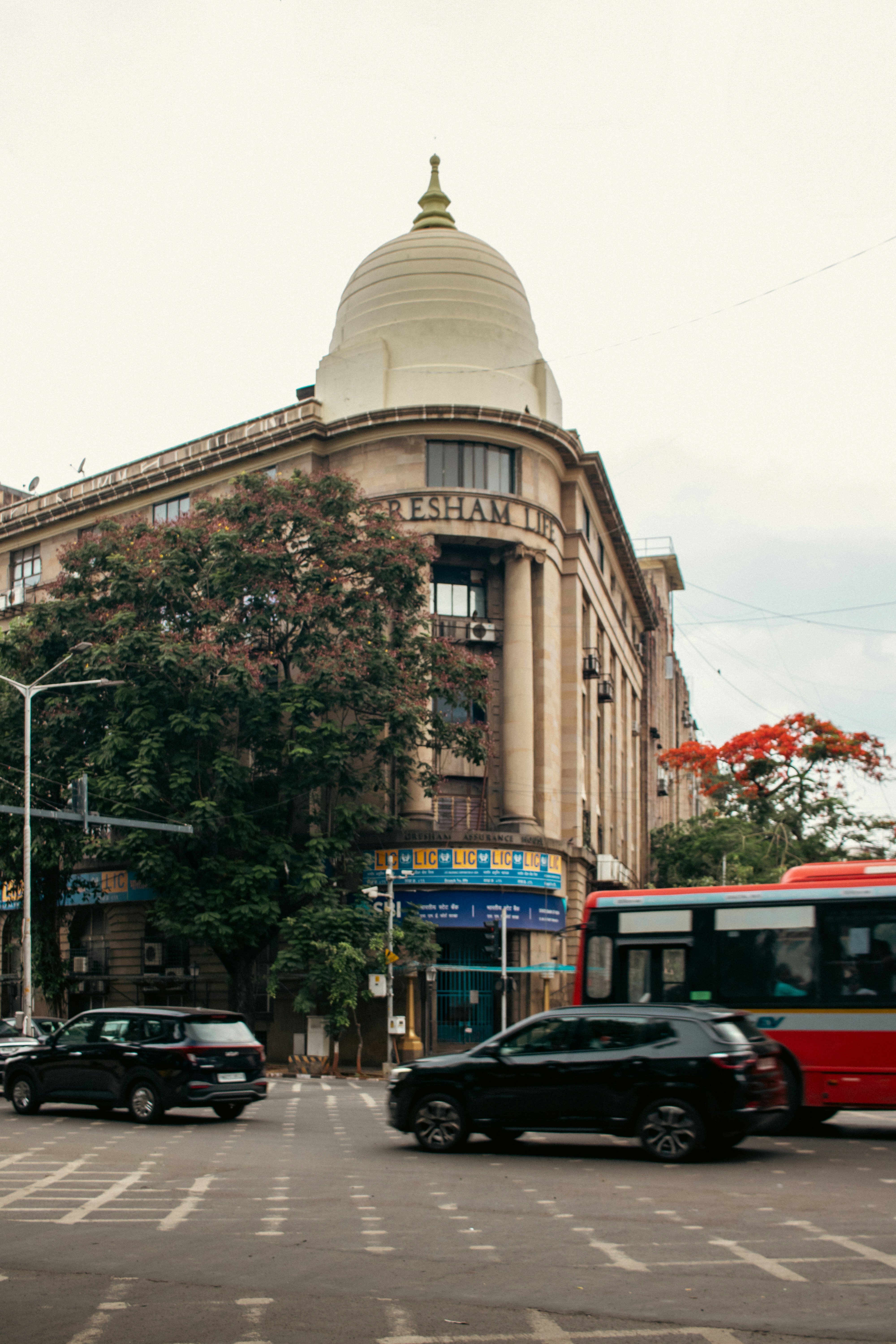 A building with a dome on a busy city street.