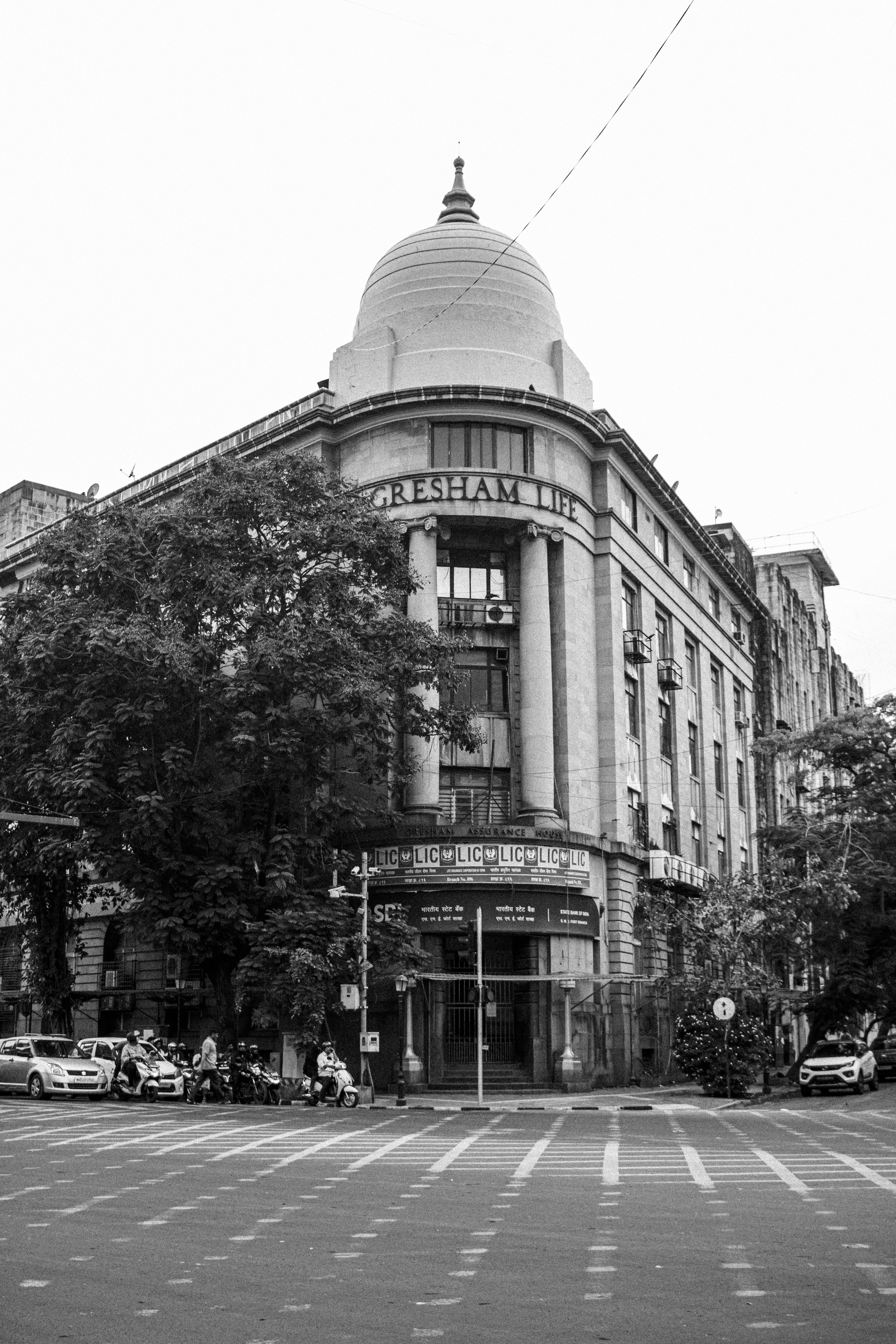 Historic building with a prominent dome stands on a corner.