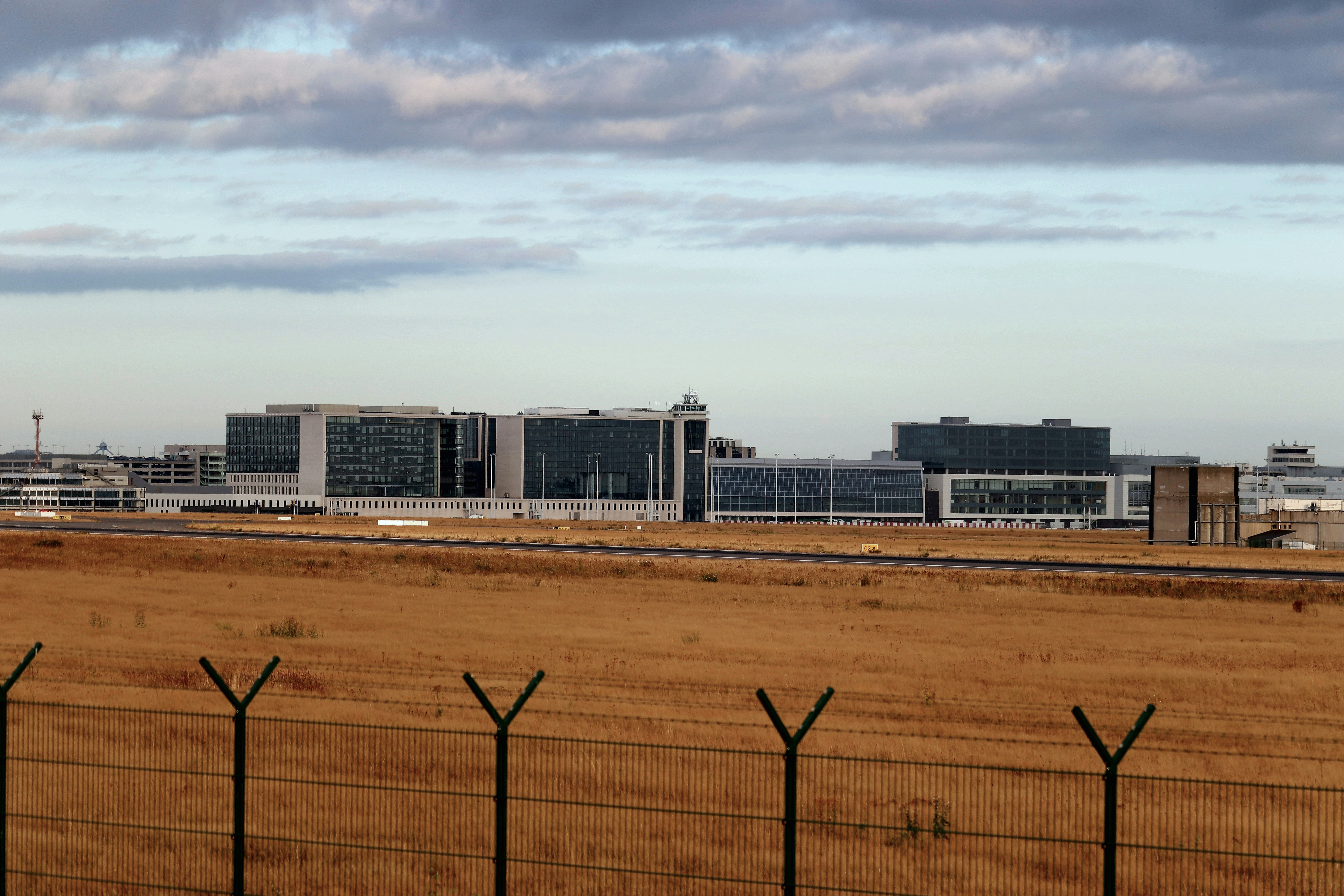 A modern building sits on a field.