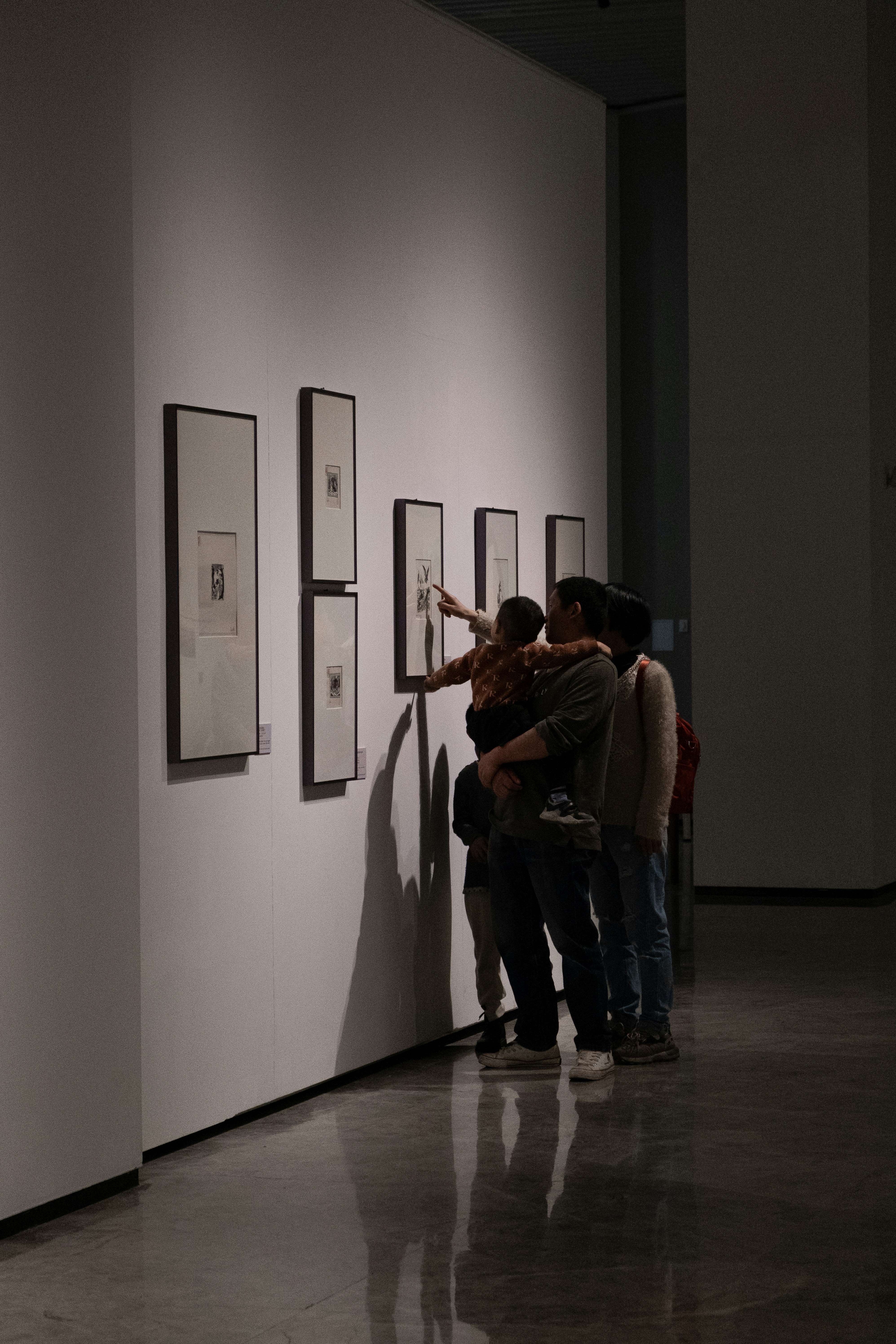People are looking at art in a gallery.