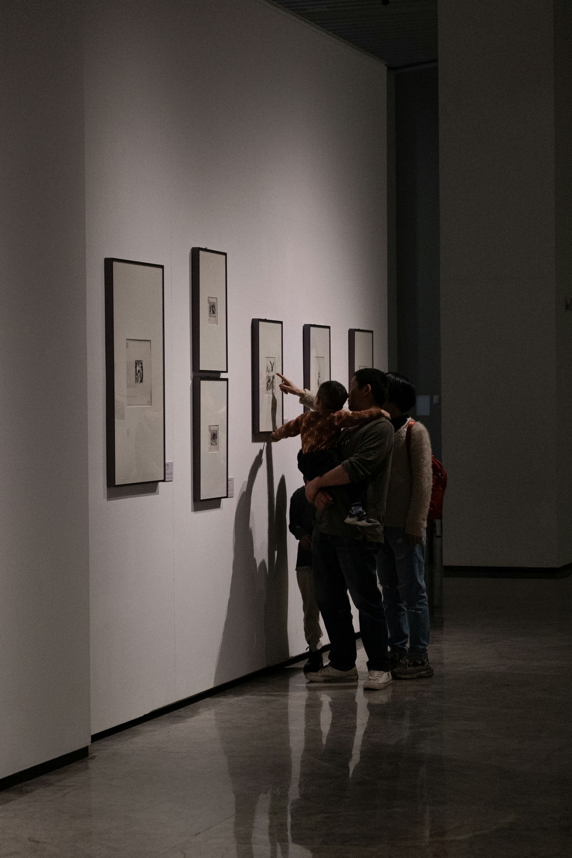 People are looking at art in a gallery.