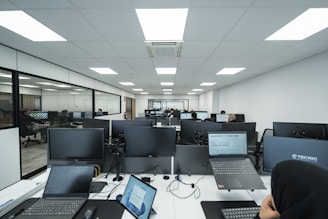 Office space filled with computers and people.