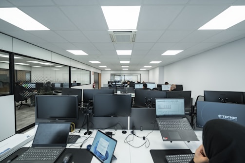 Office space filled with computers and people.