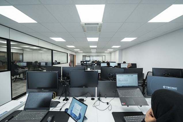 Office space filled with computers and people.