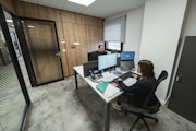 People work at desks in a modern office.