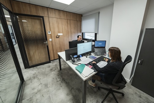 People work at desks in a modern office.
