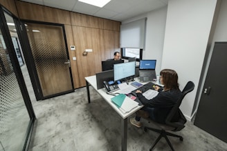 People work at desks in a modern office.
