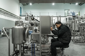 A man works on industrial machinery.