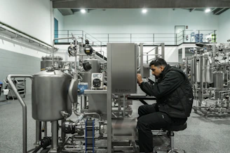A man works on industrial machinery.