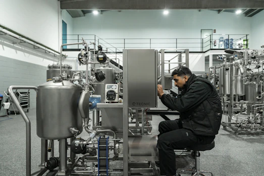 A man works on industrial machinery.