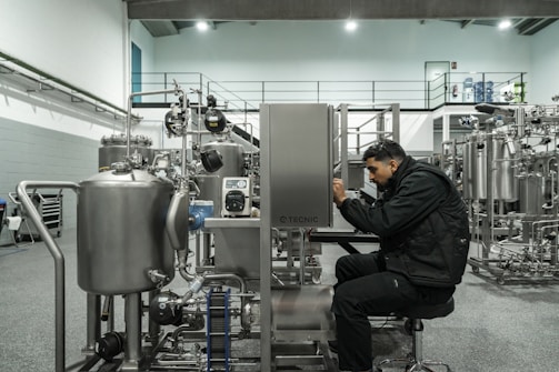 A man works on industrial machinery.