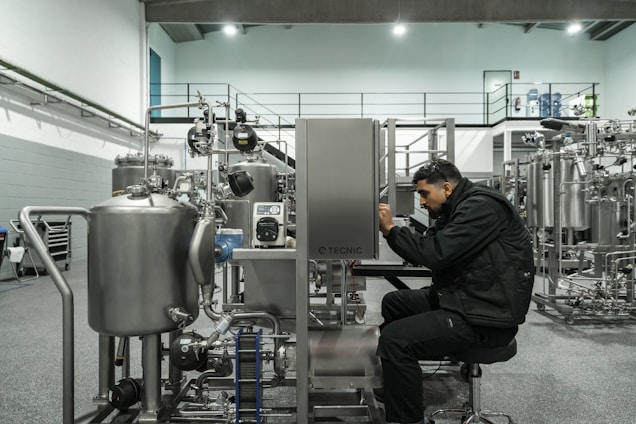 A man works on industrial machinery.