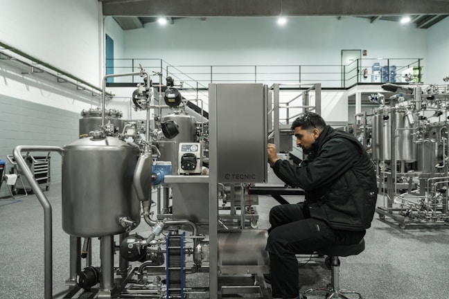 A man works on industrial machinery.