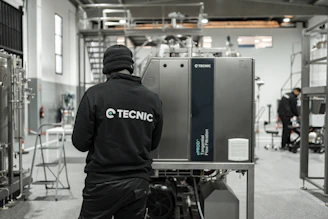Worker looking at industrial machinery in a factory