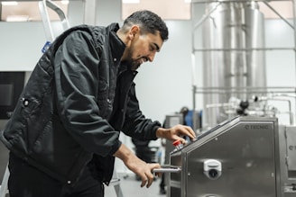 A man operates equipment in an industrial setting.