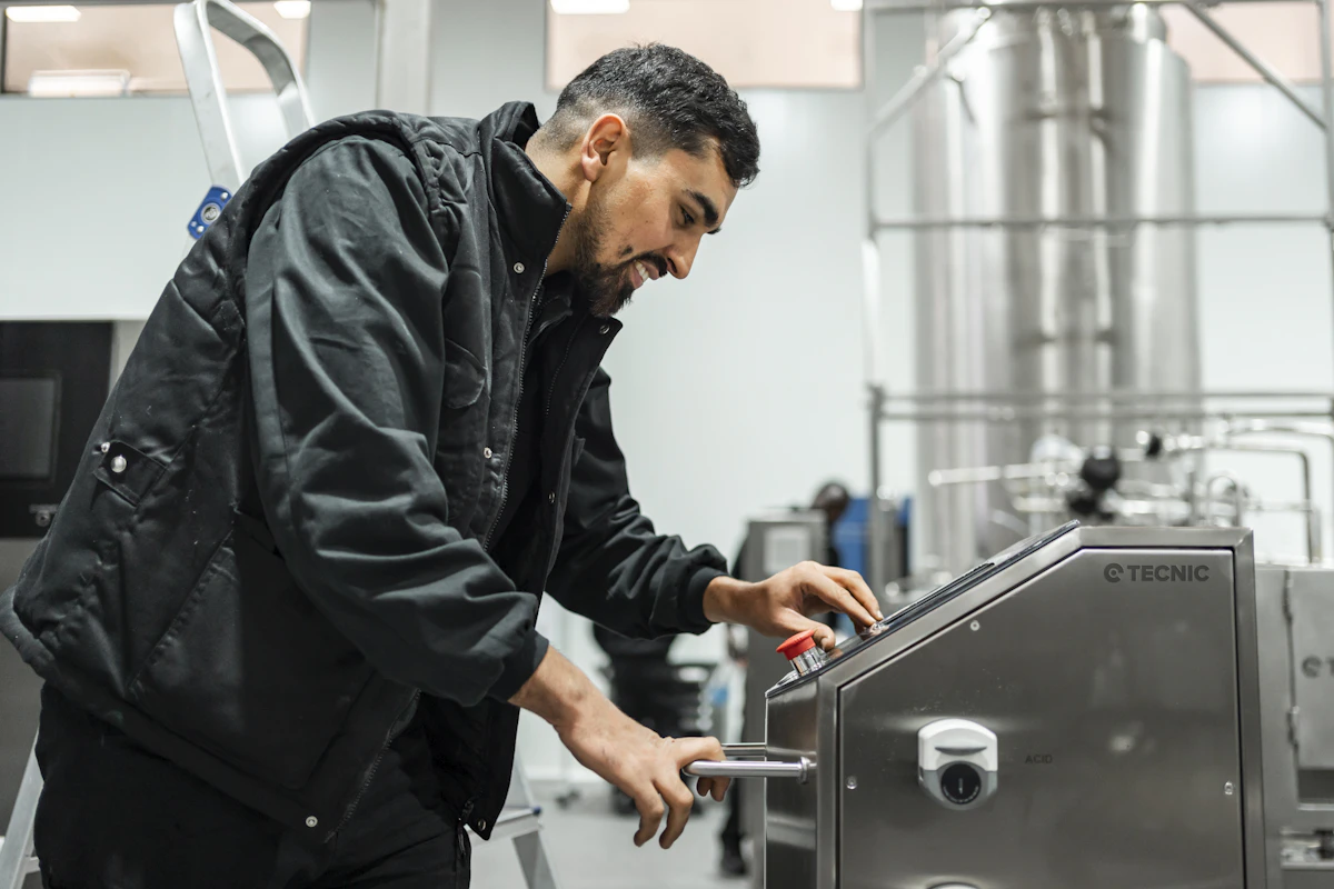 Engineer operating an industrial control panel