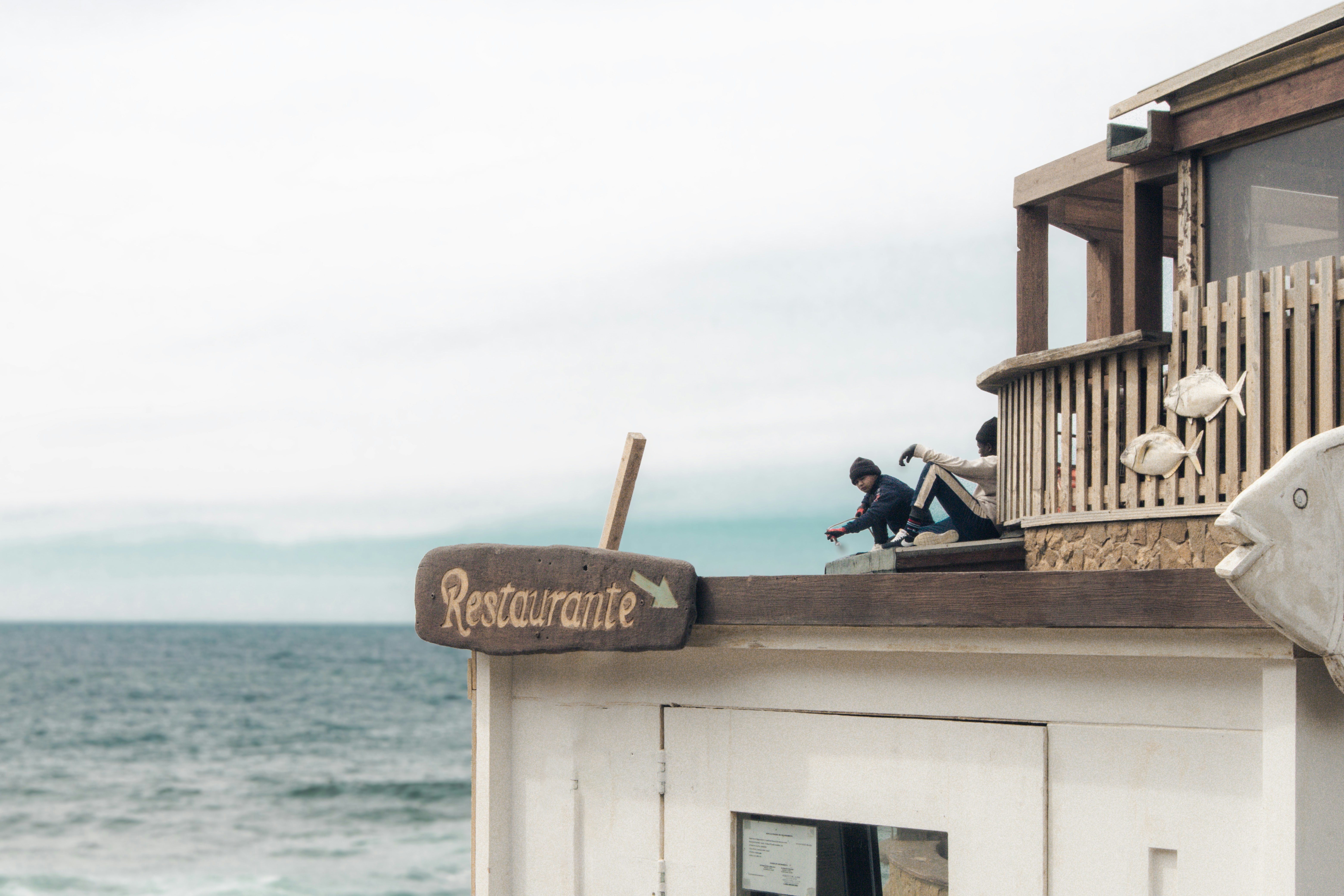 A restaurant sits by the ocean's edge