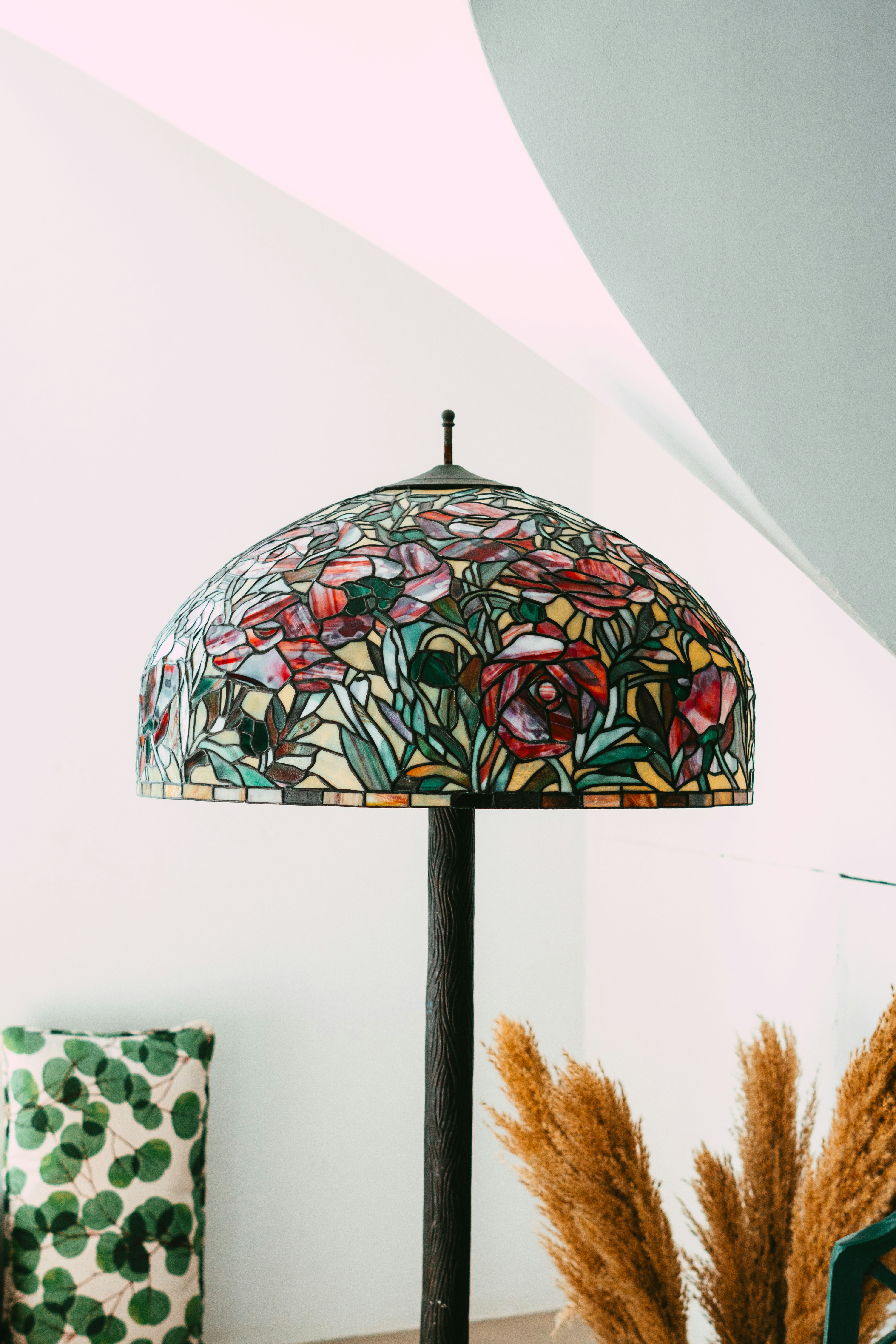 A tiffany-style lamp displays its floral stained glass