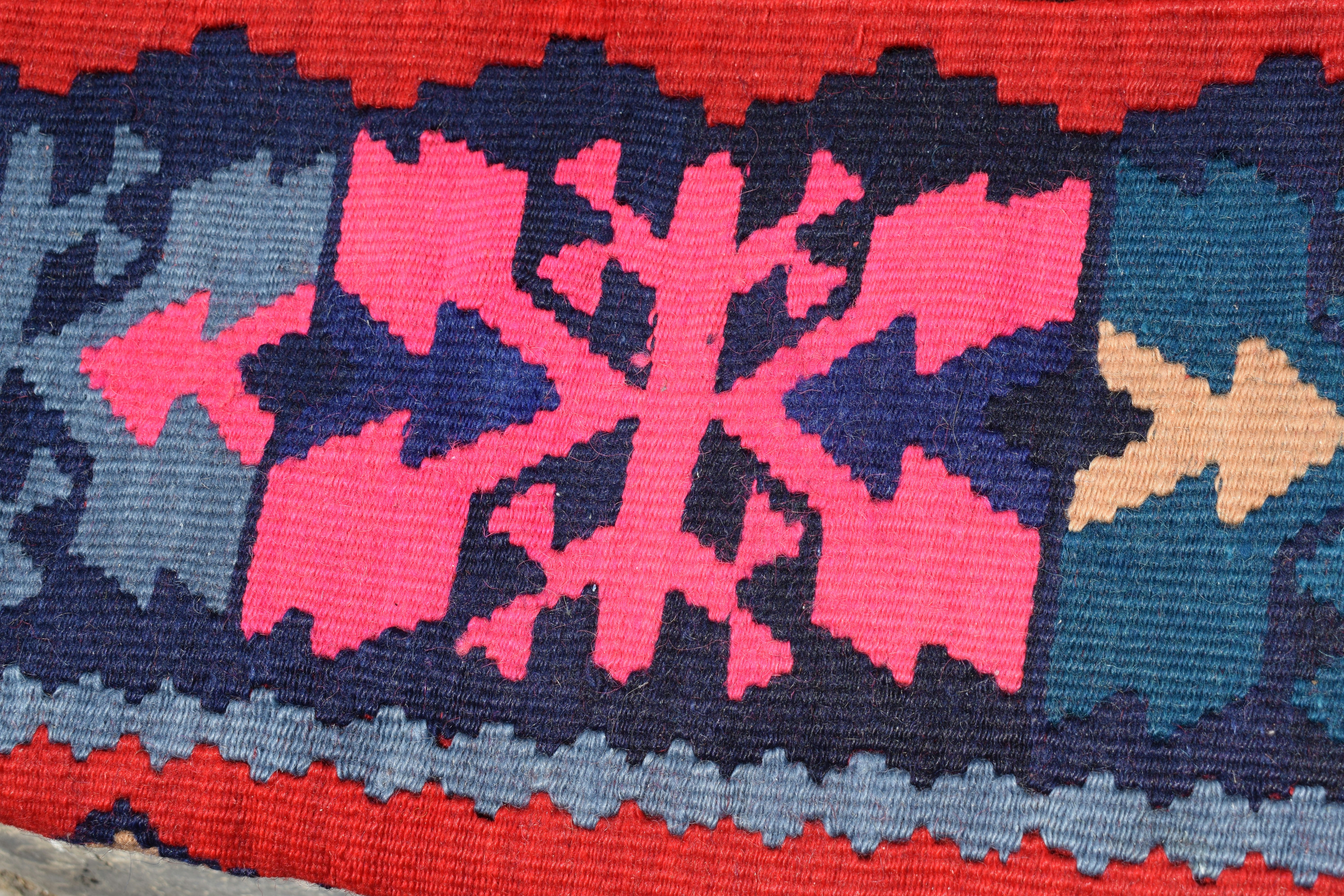 Specific alt text example: A red wool scarf with fringe