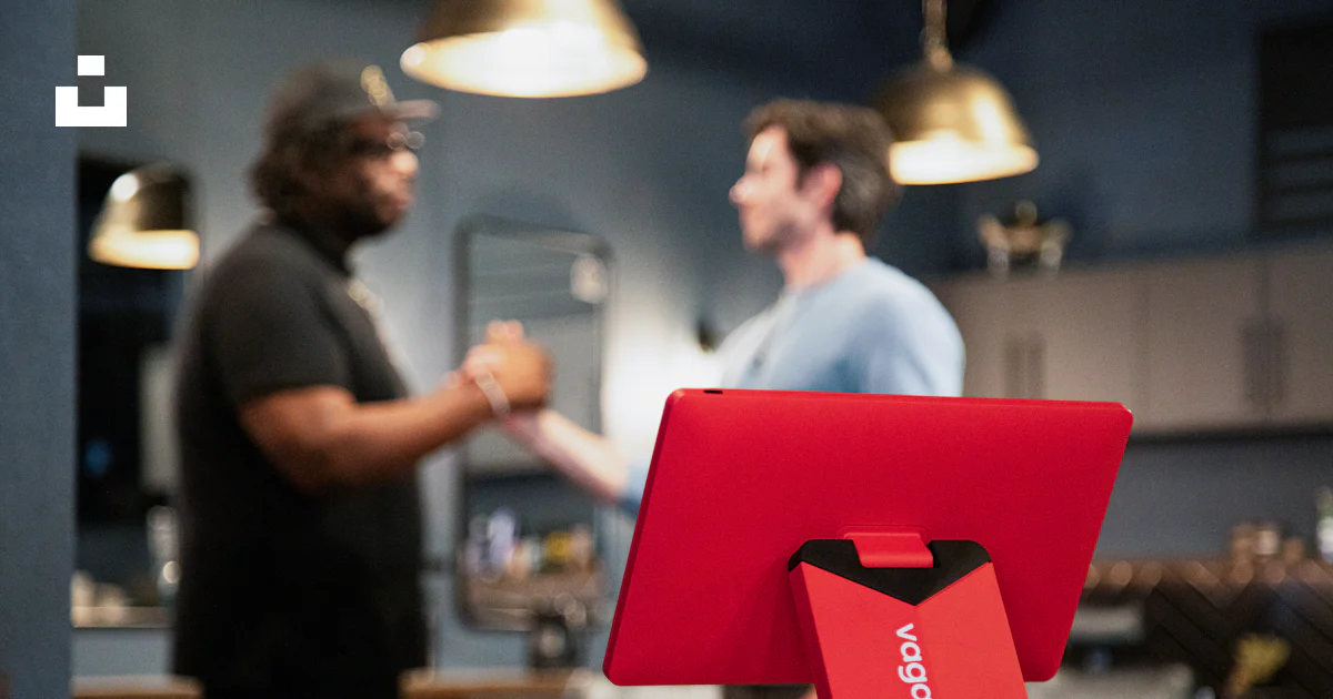 A red pos system is on a counter. photo – Free Business Image on Unsplash