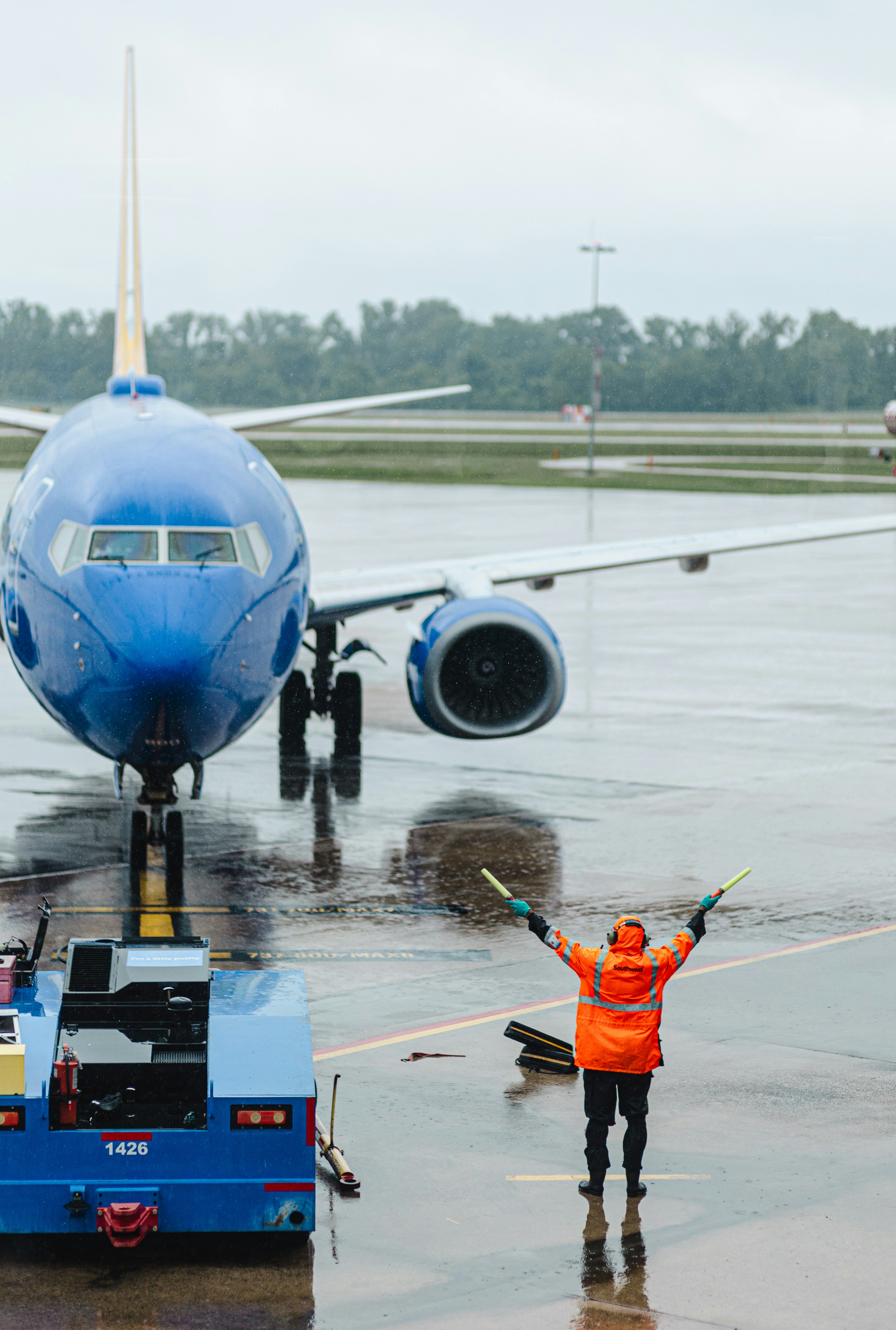 A ground crew directs a plane on the tarmac.