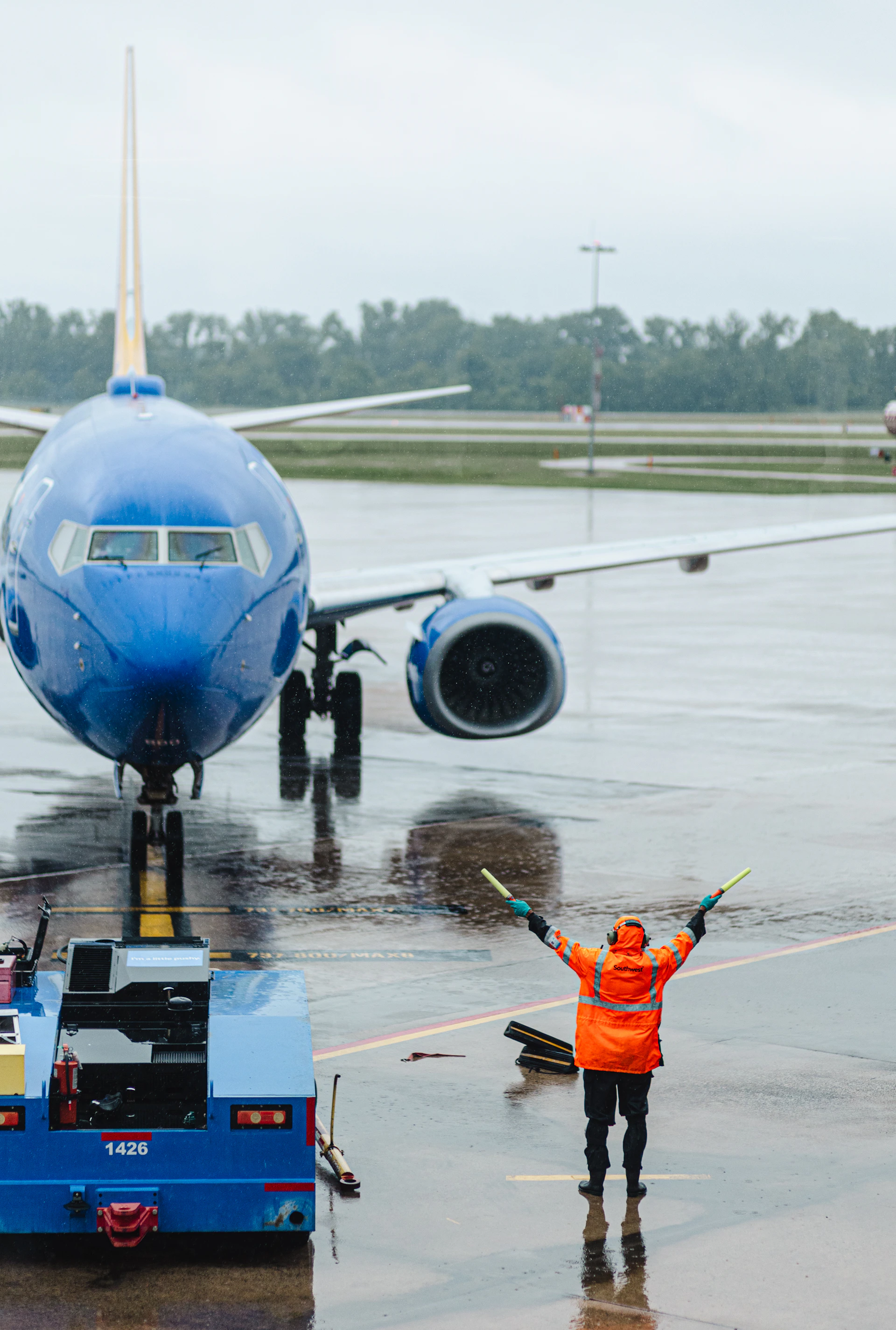 A ground crew directs a plane on the tarmac