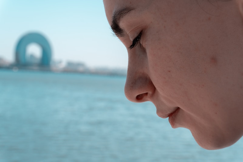 woman in thoughtful moment by water