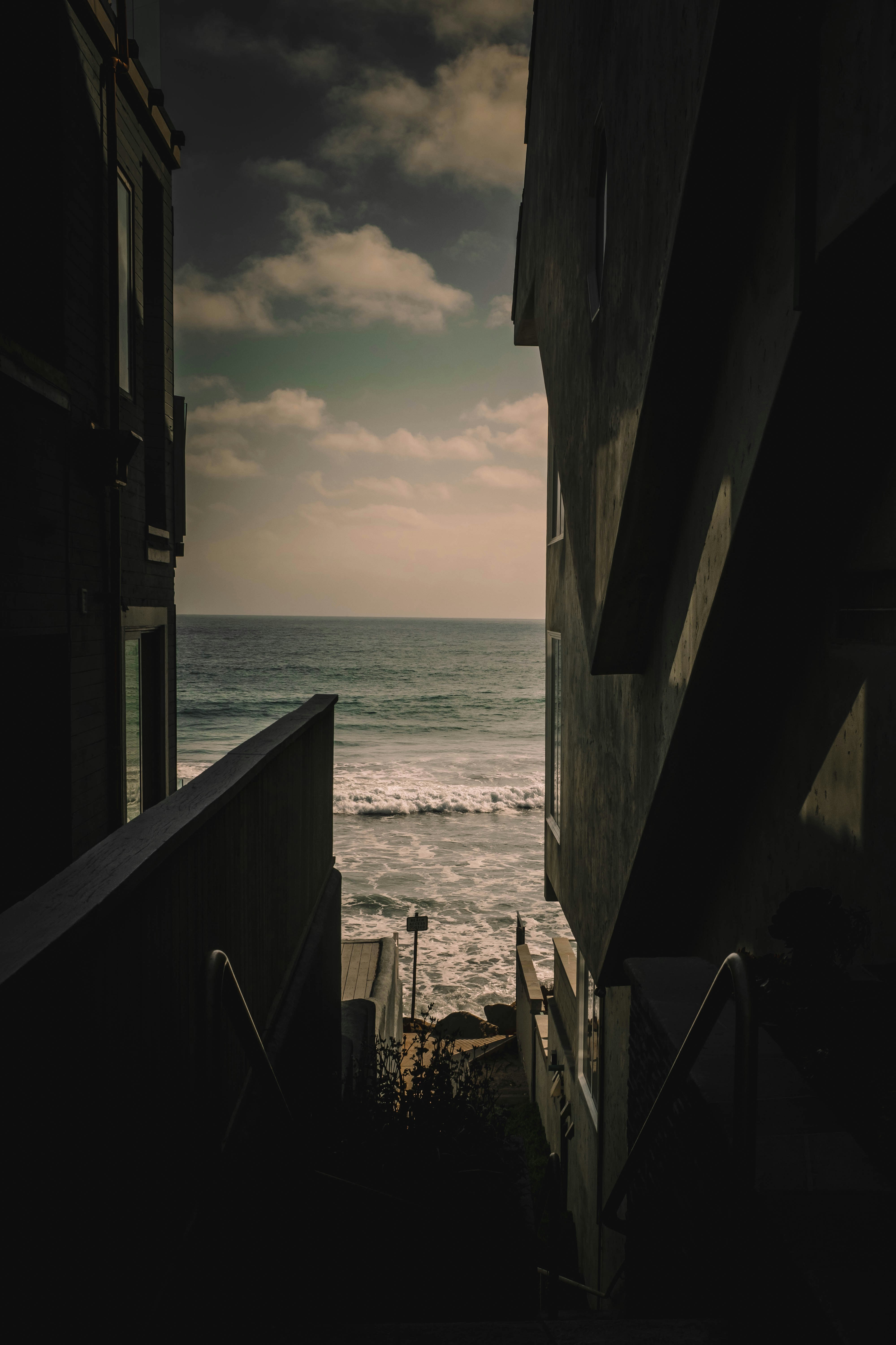Buildings frame a view of the ocean.