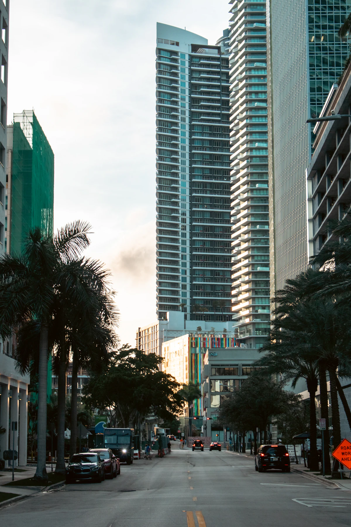 High-rise condominium towers framed by palm trees in Miami