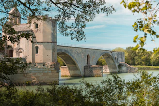 A stone bridge over water is seen here.
