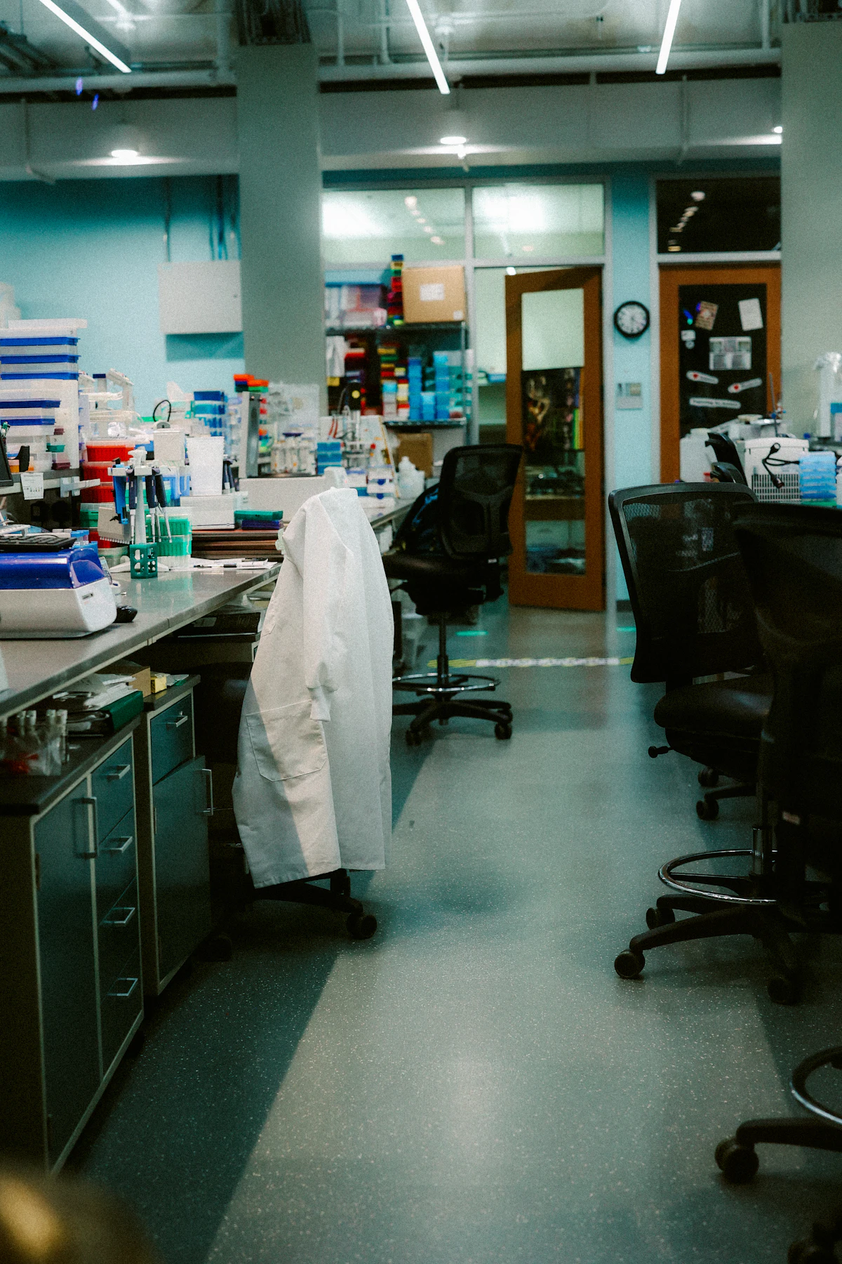 Scientists working with test tubes in a laboratory — Chugai aims to compress manual, fragmented analysis into AI-assisted workflows.