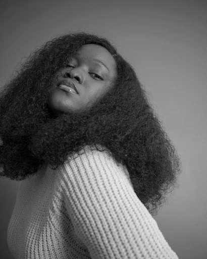 A woman poses with curly hair