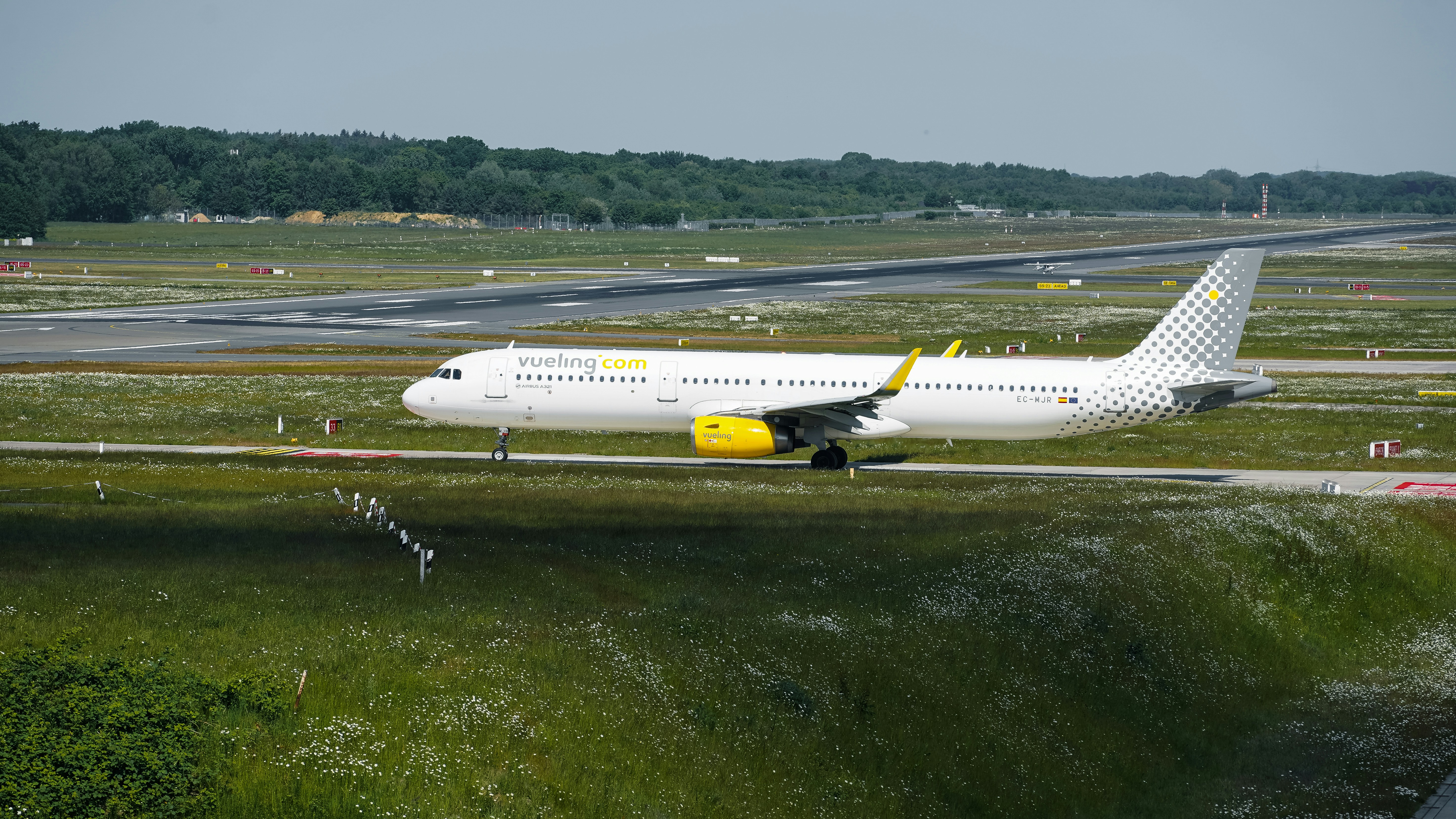 An airplane is on a runway, ready to take off.